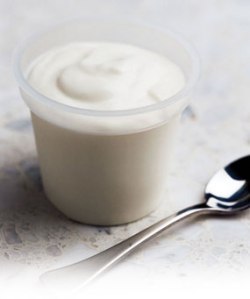 Yogurt in a tub with spoon